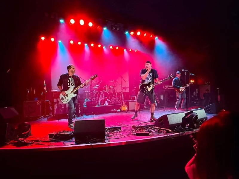 Secondhand Flannel on stage under red and blue lights