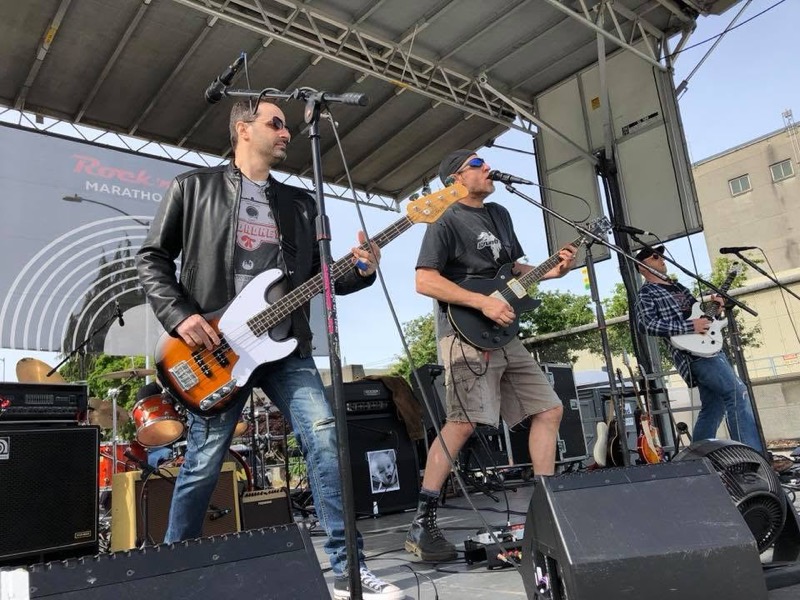 Bassist and singer on an outdoor stage